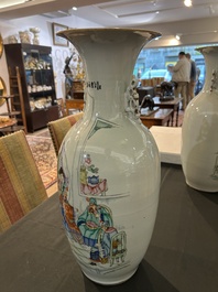 A pair of Chinese famille rose 'animated palace scene' vases, 19th/20th C.