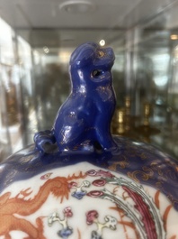 A pair of large Chinese famille rose blue-ground 'dragons and phoenixes' vases with covers, Kangxi mark, 19th C.