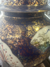 A pair of large Chinese famille rose blue-ground 'dragons and phoenixes' vases with covers, Kangxi mark, 19th C.