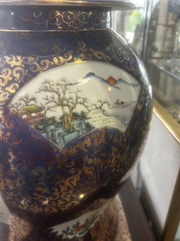 A pair of large Chinese famille rose blue-ground 'dragons and phoenixes' vases with covers, Kangxi mark, 19th C.