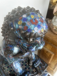 A pair of Chinese cloisonn&eacute; Buddhist lions on a wooden base, 20th C.