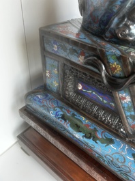 A pair of Chinese cloisonn&eacute; Buddhist lions on a wooden base, 20th C.
