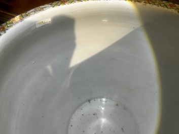 A Chinese famille rose jardini&egrave;re with birds on blossoming branches on an openworked carved wooden stand with marble top, 19th/20th C.