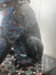 A pair of Chinese cloisonn&eacute; Buddhist lions on a wooden base, 20th C.