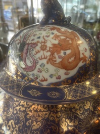 A pair of large Chinese famille rose blue-ground 'dragons and phoenixes' vases with covers, Kangxi mark, 19th C.