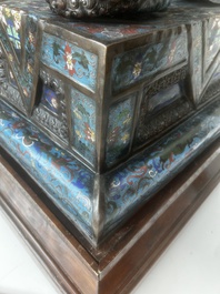 A pair of Chinese cloisonn&eacute; Buddhist lions on a wooden base, 20th C.