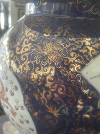 A pair of large Chinese famille rose blue-ground 'dragons and phoenixes' vases with covers, Kangxi mark, 19th C.