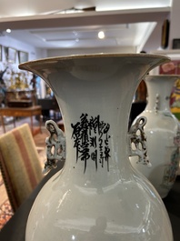 A pair of Chinese famille rose 'animated palace scene' vases, 19th/20th C.