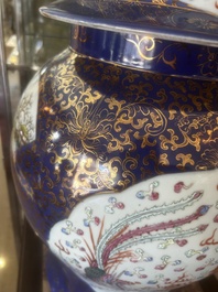 A pair of large Chinese famille rose blue-ground 'dragons and phoenixes' vases with covers, Kangxi mark, 19th C.