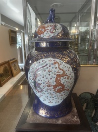 A pair of large Chinese famille rose blue-ground 'dragons and phoenixes' vases with covers, Kangxi mark, 19th C.