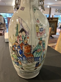 A pair of Chinese famille rose 'animated palace scene' vases, 19th/20th C.