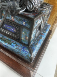 A pair of Chinese cloisonn&eacute; Buddhist lions on a wooden base, 20th C.