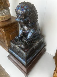A pair of Chinese cloisonn&eacute; Buddhist lions on a wooden base, 20th C.