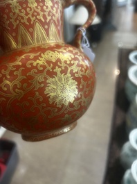 A Chinese ewer-shaped coral-red ground wall pocket vase with gilt lotus scrolls, Qianlong mark, 20th C.