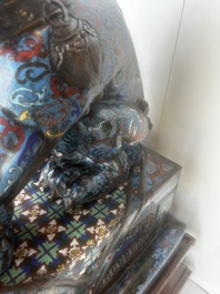 A pair of Chinese cloisonn&eacute; Buddhist lions on a wooden base, 20th C.