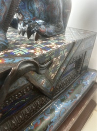 A pair of Chinese cloisonn&eacute; Buddhist lions on a wooden base, 20th C.