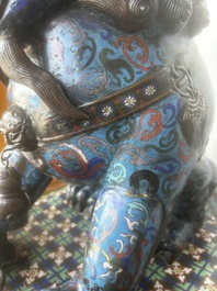 A pair of Chinese cloisonn&eacute; Buddhist lions on a wooden base, 20th C.