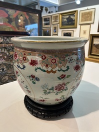 A Chinese famille rose jardini&egrave;re with floral design on a wooden base, 19th C.