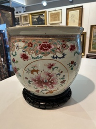 A Chinese famille rose jardini&egrave;re with floral design on a wooden base, 19th C.