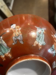 A Chinese coral-red ground famille verte bowl with playing boys, 19th/20th C.