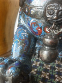 A pair of Chinese cloisonn&eacute; Buddhist lions on a wooden base, 20th C.