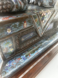 A pair of Chinese cloisonn&eacute; Buddhist lions on a wooden base, 20th C.