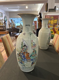 A pair of Chinese famille rose 'animated palace scene' vases, 19th/20th C.