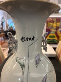 A pair of Chinese famille rose 'animated palace scene' vases, 19th/20th C.