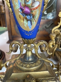 A French gilt bronze three-piece clock garniture crowned with a lady holding a jewelry box, 19th C.