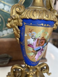A French gilt bronze three-piece clock garniture crowned with a lady holding a jewelry box, 19th C.