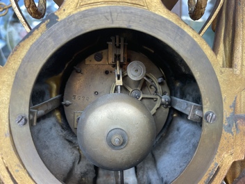 A French gilt bronze three-piece clock garniture crowned with a lady holding a jewelry box, 19th C.