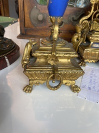 A French gilt bronze three-piece clock garniture crowned with a lady holding a jewelry box, 19th C.