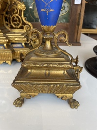 A French gilt bronze three-piece clock garniture crowned with a lady holding a jewelry box, 19th C.