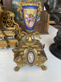 A French gilt bronze three-piece clock garniture crowned with a lady holding a jewelry box, 19th C.