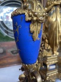 A French gilt bronze three-piece clock garniture crowned with a lady holding a jewelry box, 19th C.