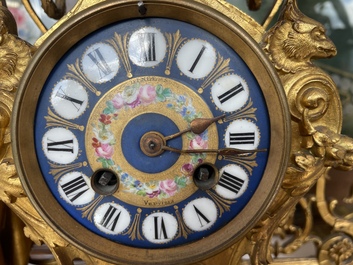 A French gilt bronze three-piece clock garniture crowned with a lady holding a jewelry box, 19th C.