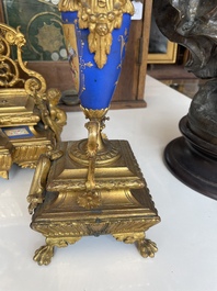 A French gilt bronze three-piece clock garniture crowned with a lady holding a jewelry box, 19th C.