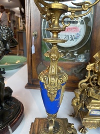 A French gilt bronze three-piece clock garniture crowned with a lady holding a jewelry box, 19th C.