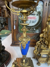 A French gilt bronze three-piece clock garniture crowned with a lady holding a jewelry box, 19th C.