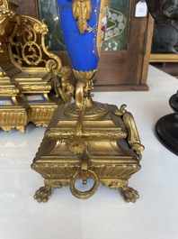 A French gilt bronze three-piece clock garniture crowned with a lady holding a jewelry box, 19th C.