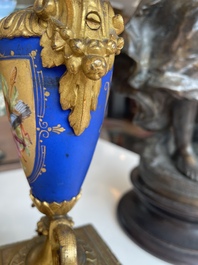 A French gilt bronze three-piece clock garniture crowned with a lady holding a jewelry box, 19th C.