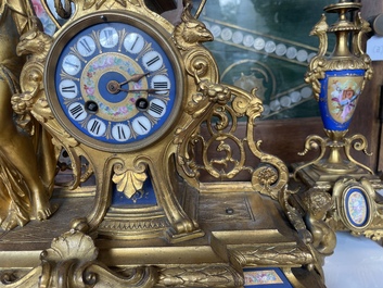 A French gilt bronze three-piece clock garniture crowned with a lady holding a jewelry box, 19th C.