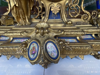 A French gilt bronze three-piece clock garniture crowned with a lady holding a jewelry box, 19th C.