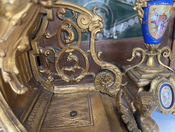 A French gilt bronze three-piece clock garniture crowned with a lady holding a jewelry box, 19th C.