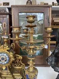 A French gilt bronze three-piece clock garniture crowned with a lady holding a jewelry box, 19th C.