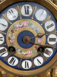 A French gilt bronze three-piece clock garniture crowned with a lady holding a jewelry box, 19th C.