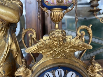 A French gilt bronze three-piece clock garniture crowned with a lady holding a jewelry box, 19th C.