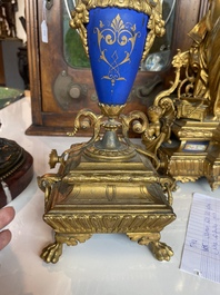 A French gilt bronze three-piece clock garniture crowned with a lady holding a jewelry box, 19th C.