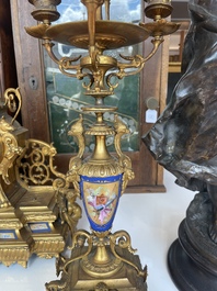 A French gilt bronze three-piece clock garniture crowned with a lady holding a jewelry box, 19th C.