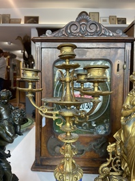A French gilt bronze three-piece clock garniture crowned with a lady holding a jewelry box, 19th C.